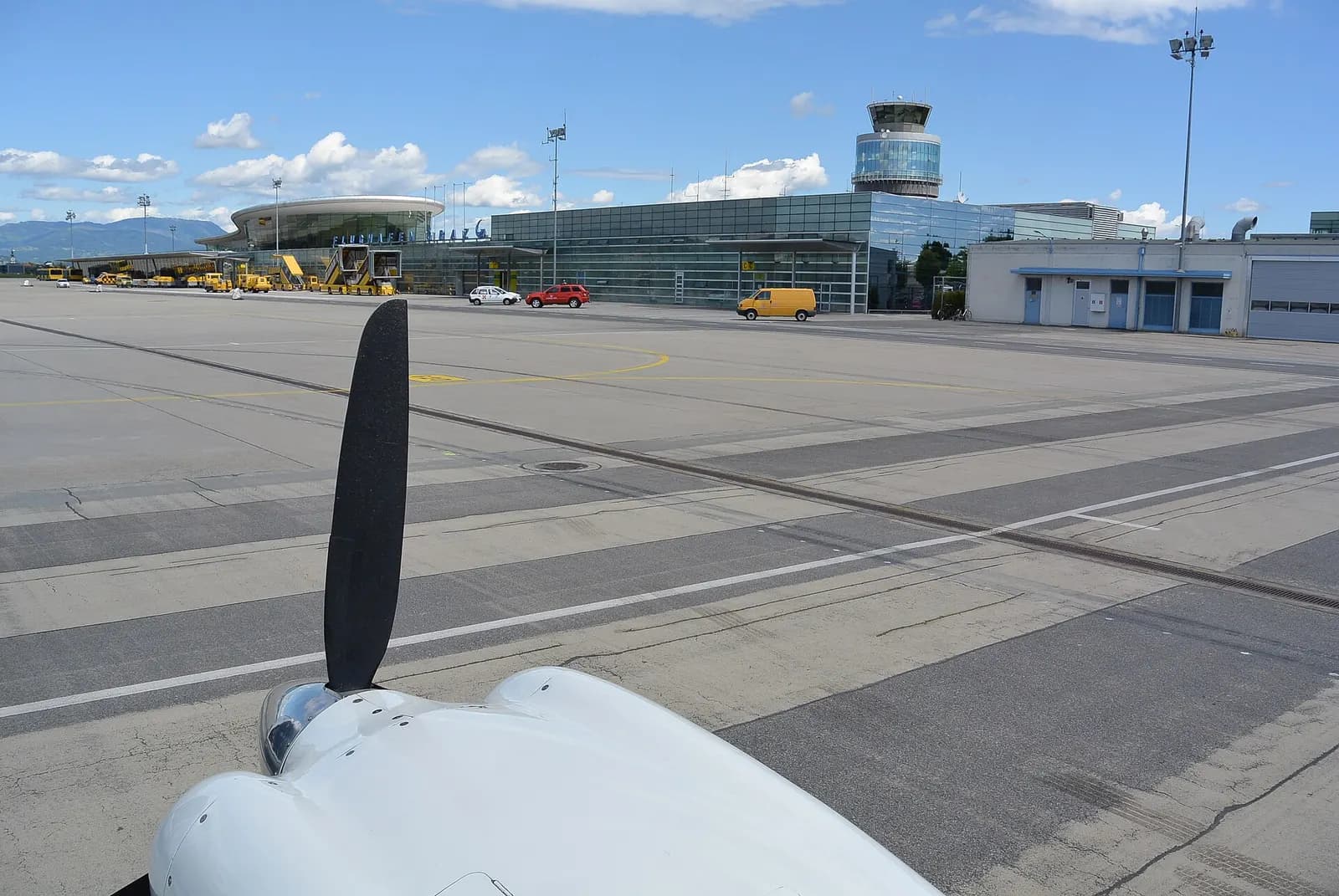 Apron and terminal complex at Graz Airport under clear Styrian sky