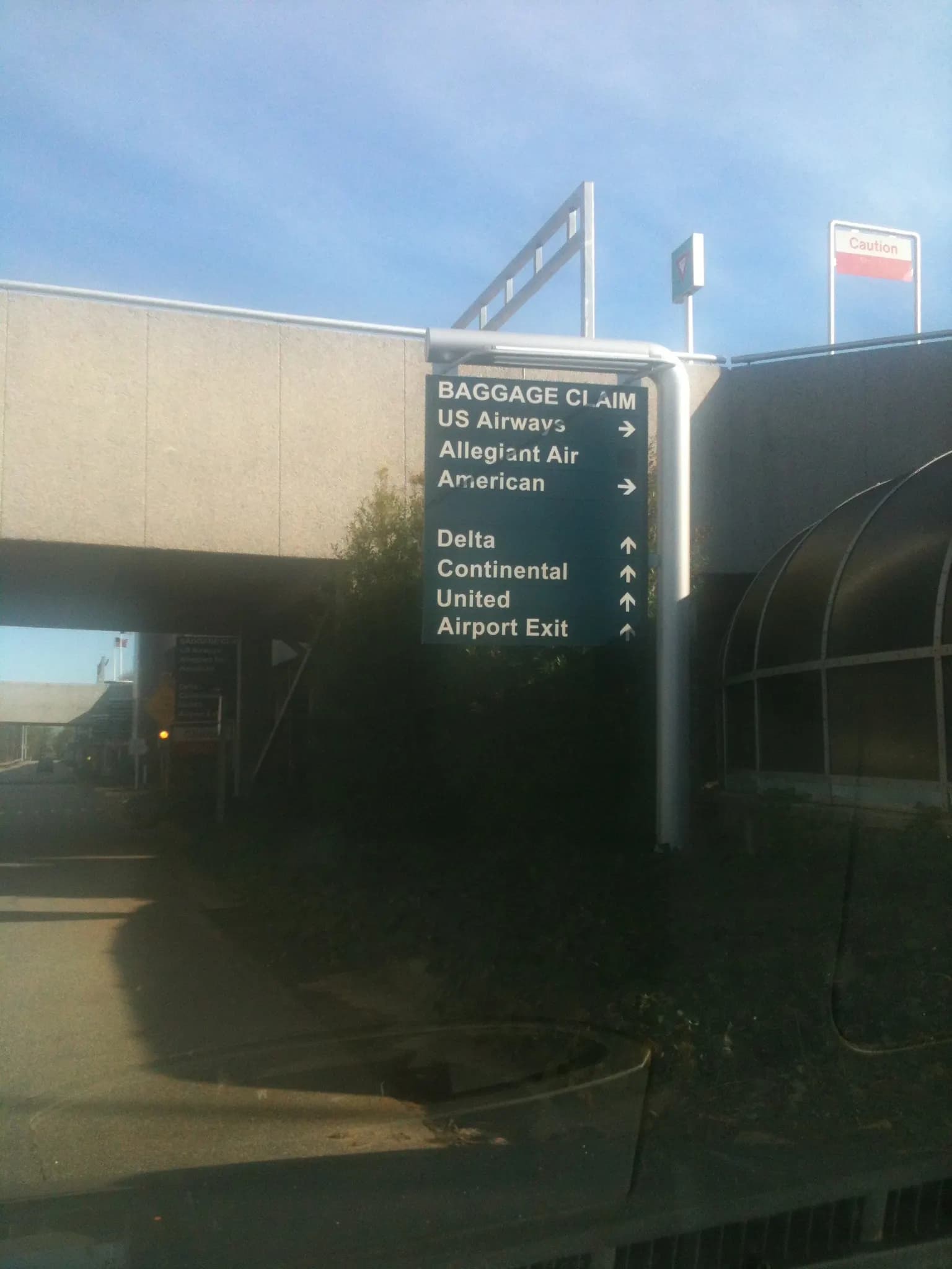 Vertical 2011 roadside sign reading Piedmont Triad International Airport PTI GSO in Greensboro, North Carolina.