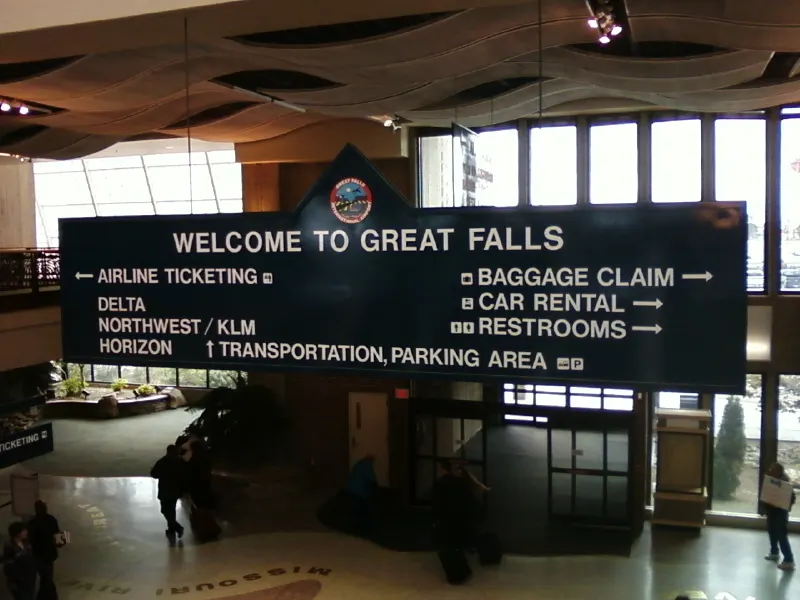Welcome to Great Falls sign inside the Great Falls International Airport terminal.
