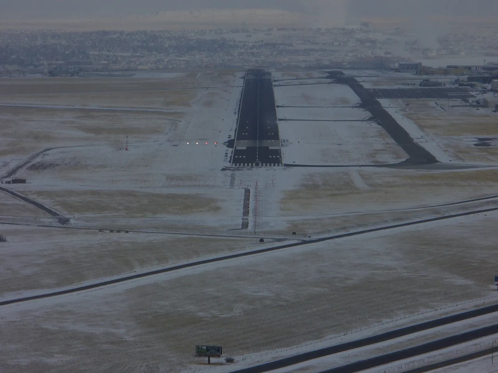 Aircraft on final approach to Great Falls International Airport over the Montana landscape.