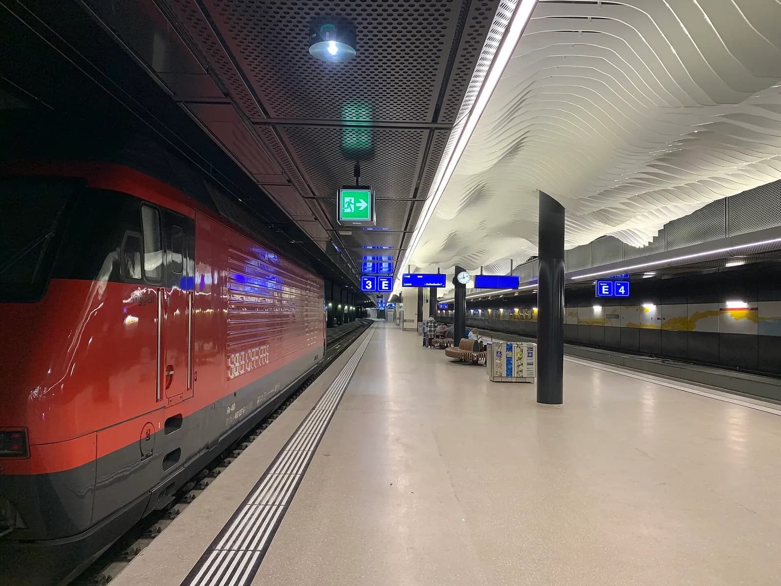 The modern glass-fronted building of the renovated Genève-Aéroport railway station beside the airport.