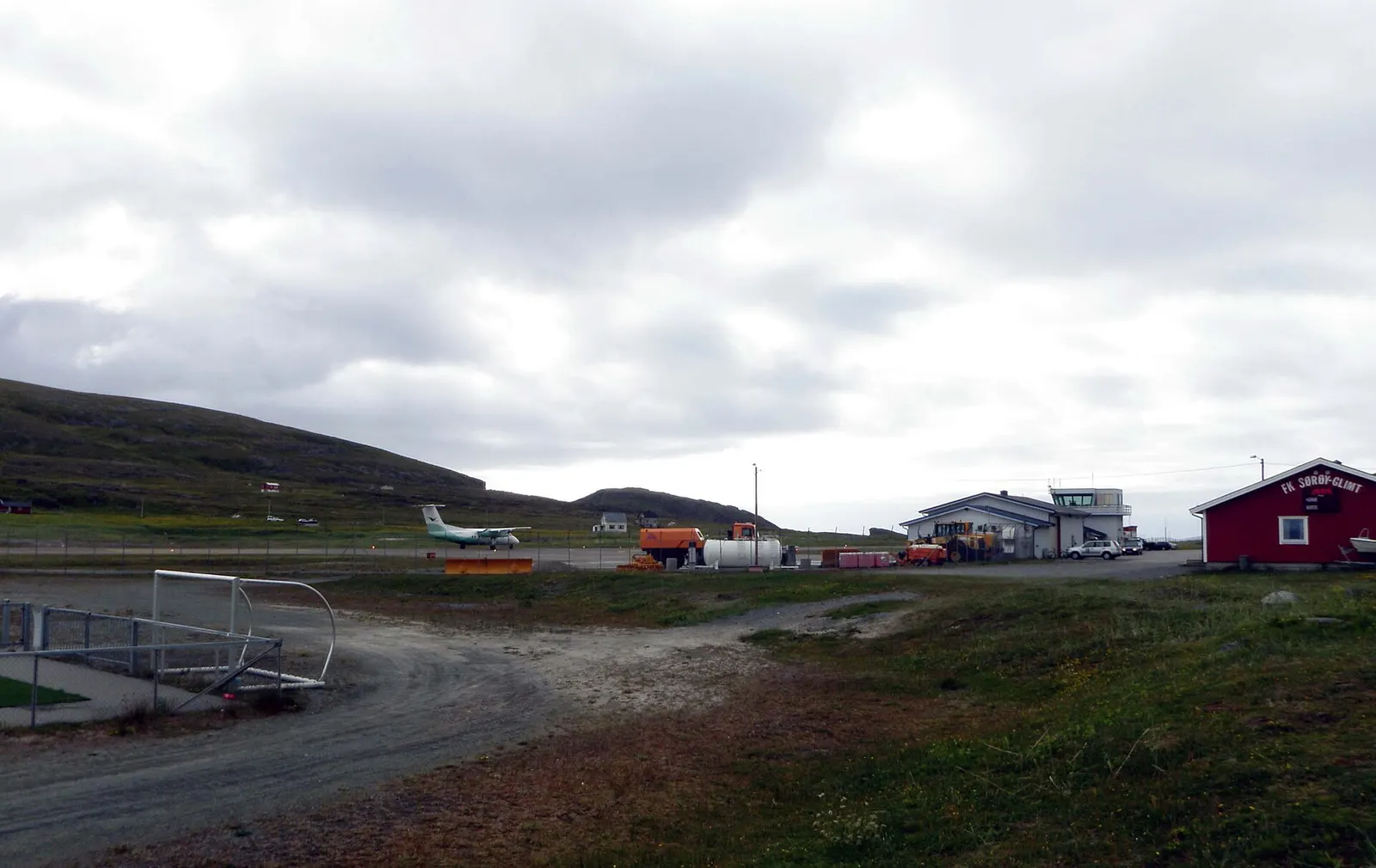 View of Hasvik Airport , in Hasvik , Finnmark, Norway. A Bombardier Dash 8 aircraft from the airline Widerøe is seen in the process of taking off.