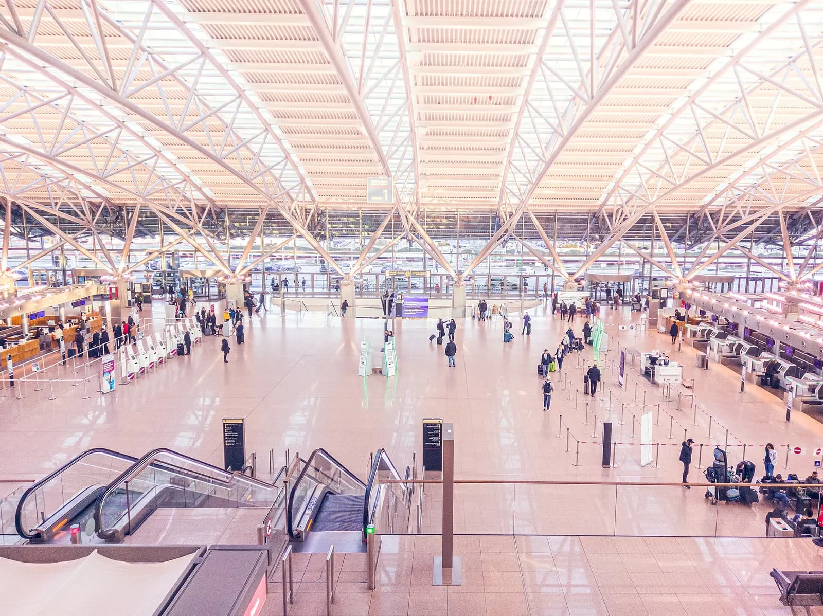 An overview of Hamburg Airport Terminal 2 showing its multi-level layout, glass walls, and passenger areas.