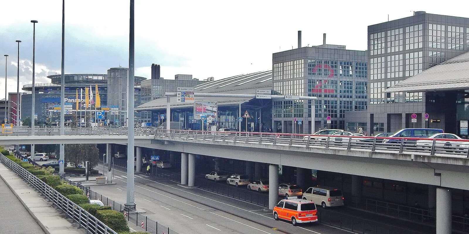 A panoramic landscape view of Hamburg Airport facilities, runways, and buildings under an open sky.