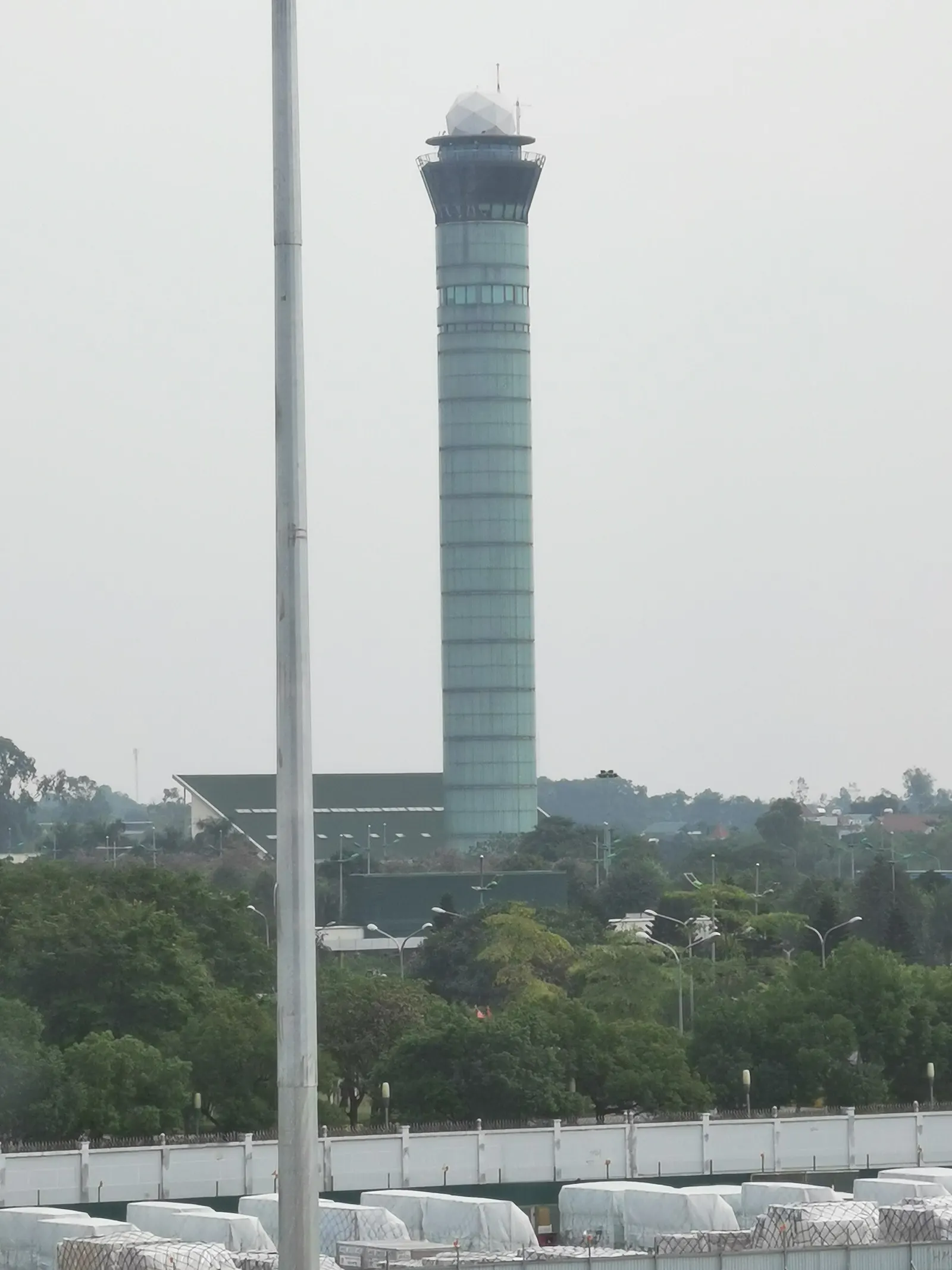 The control tower of Noi Bai International Airport taken from the International Terminal on 13 December 2023