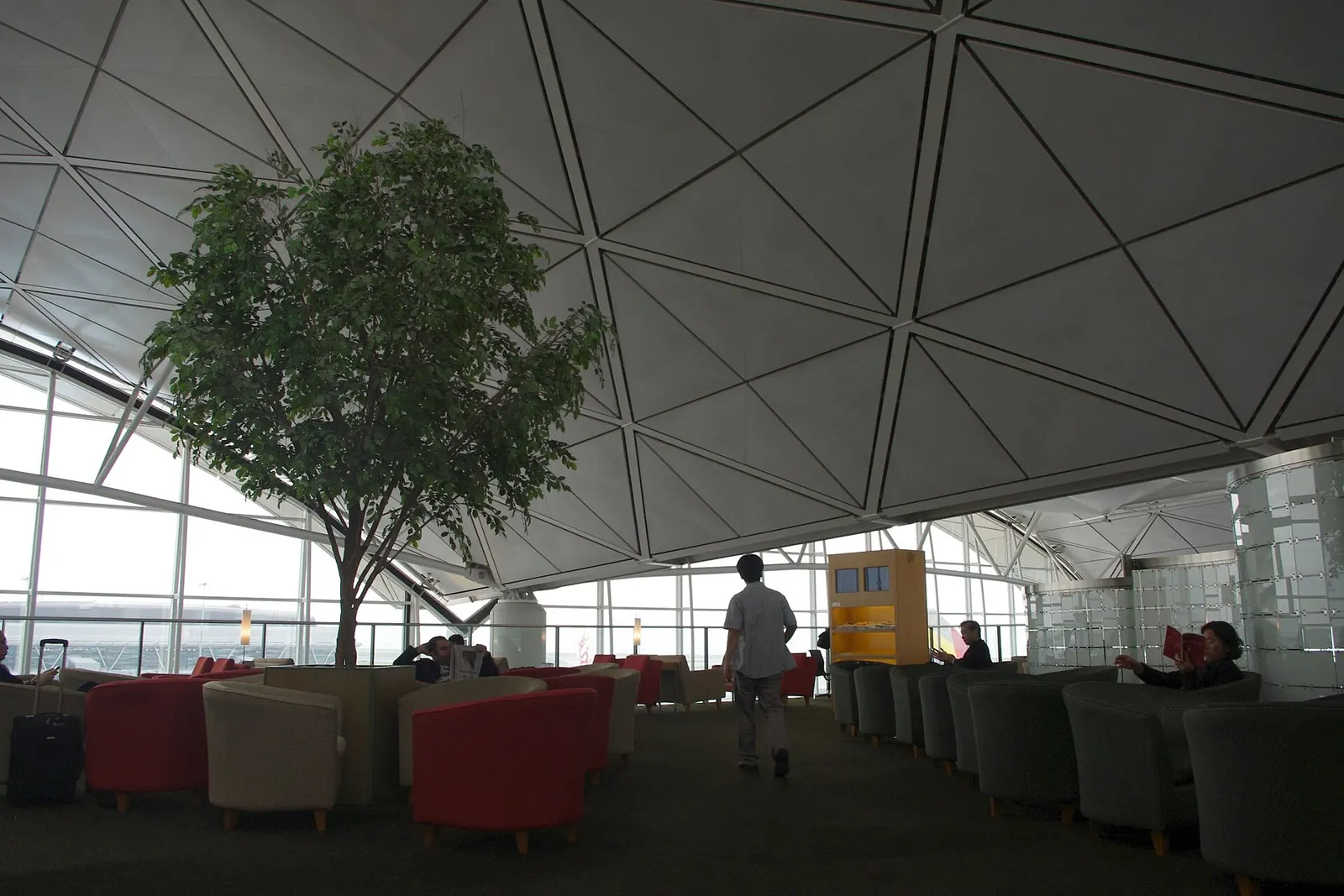 Seating and amenities inside the Gate 16 departure lounge shared by Dragonair and partner airlines.