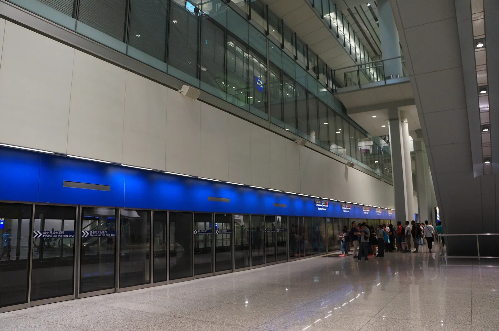 Platform at the airport automated people mover East Hall Station with tracks leading toward remote concourses.