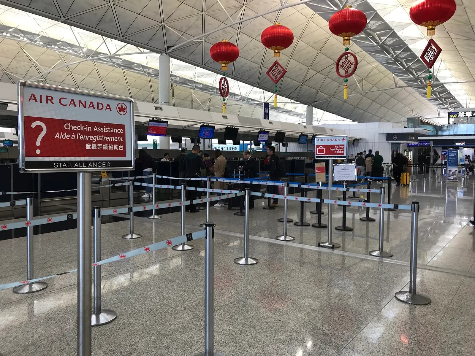Row of airline check-in counters including Air Canada in the Terminal 1 departures hall.