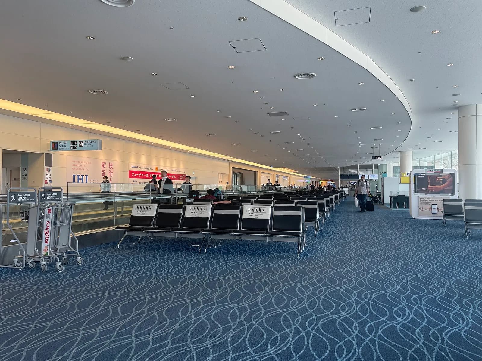 International departure boarding area in Terminal 3 with gate seating, flight information displays, and aircraft visible through large windows.