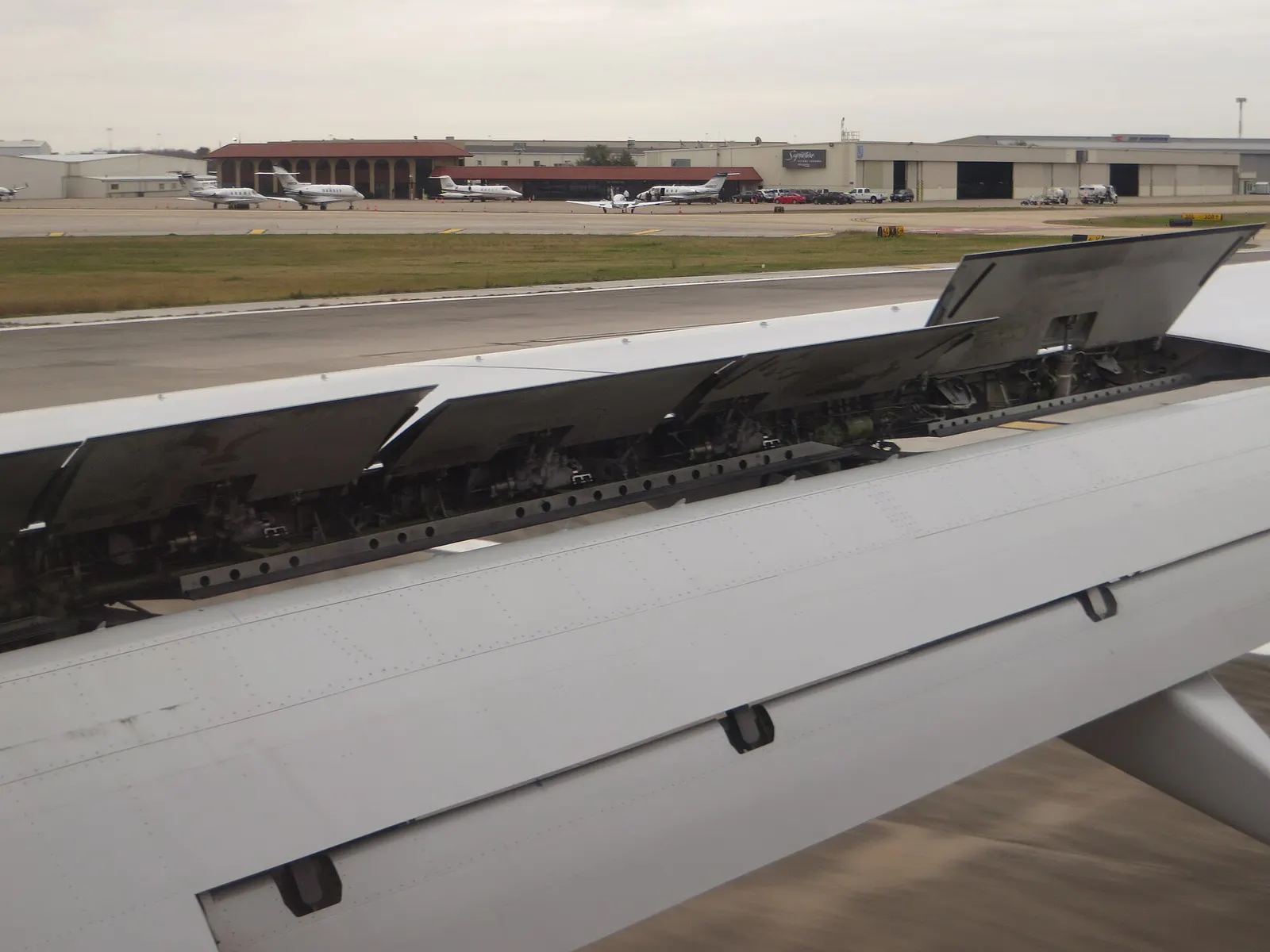 In aeronautics, a spoiler (sometimes called a lift dumper) is a device intended to reduce lift in an aircraft. Spoilers are plates on the top surface of a wing that can be extended upward into the airflow to spoil it. By so doing, the spoiler creates a controlled stall over the portion of the wing b