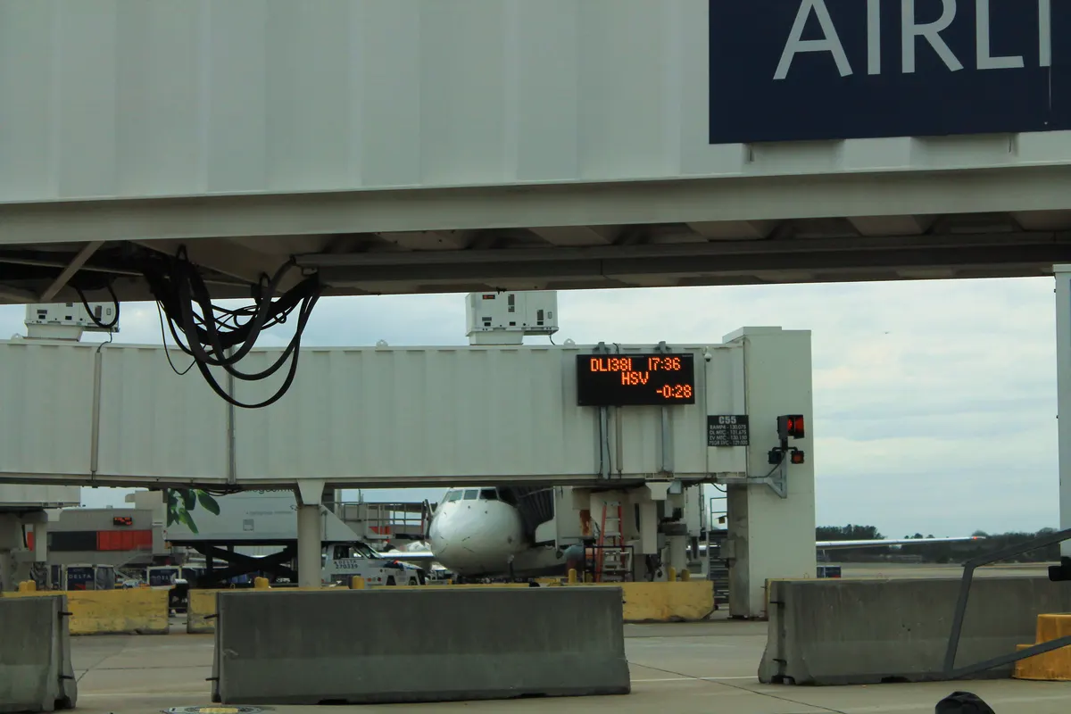 Gate information display and jet bridge at Huntsville International Airport in March 2016.