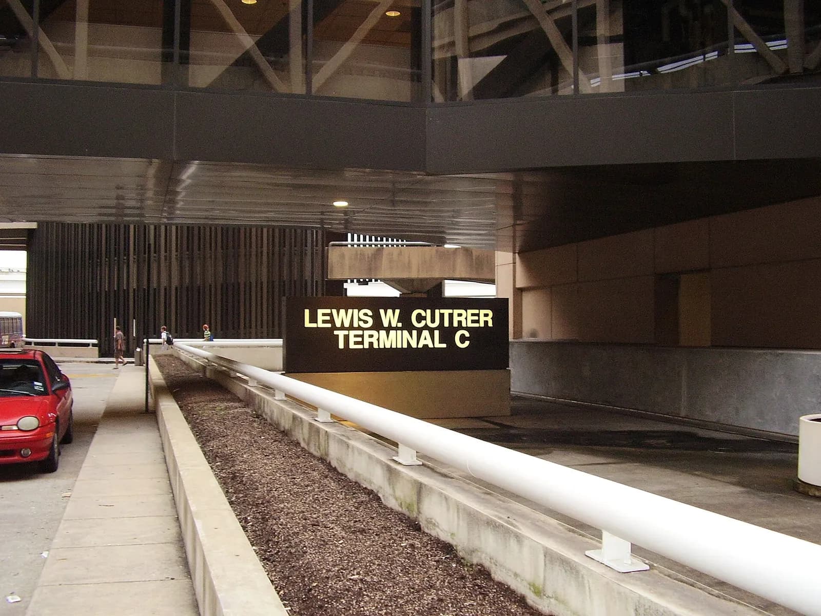 Close-up of the overhead sign reading Lewis W. Cutrer Terminal C at George Bush Intercontinental Airport.