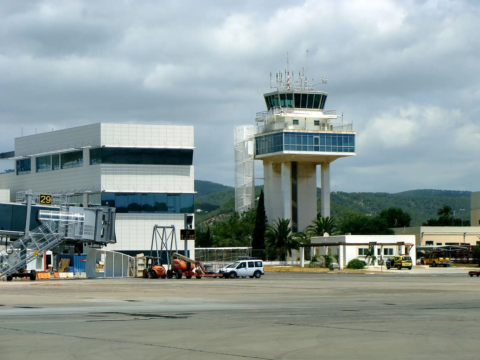 Ibiza Airport air traffic control tower beside the terminal apron.