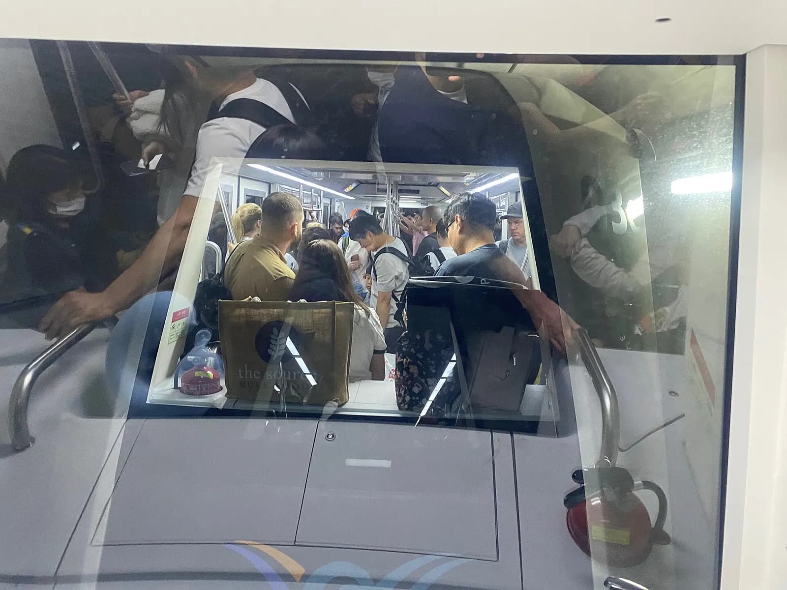 An automated people-mover train inside Incheon Airport connecting terminal concourses along an elevated guideway.