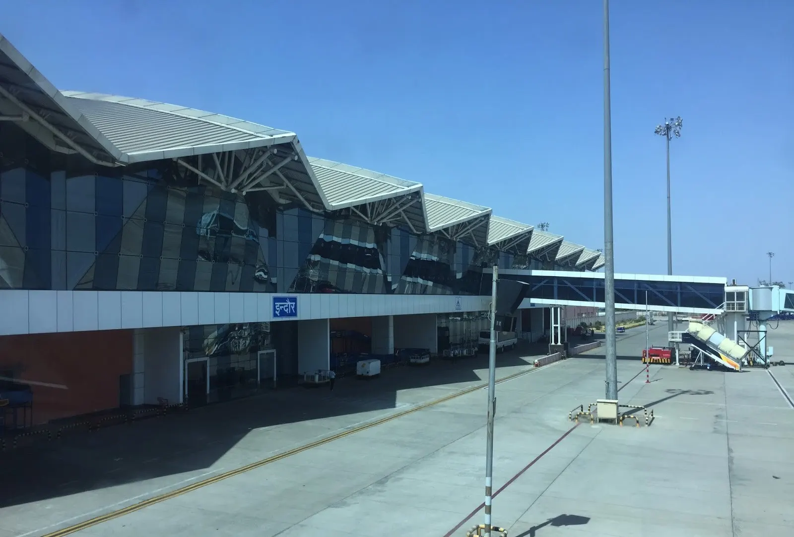 Indore airport terminal exterior photographed from an aerobridge
