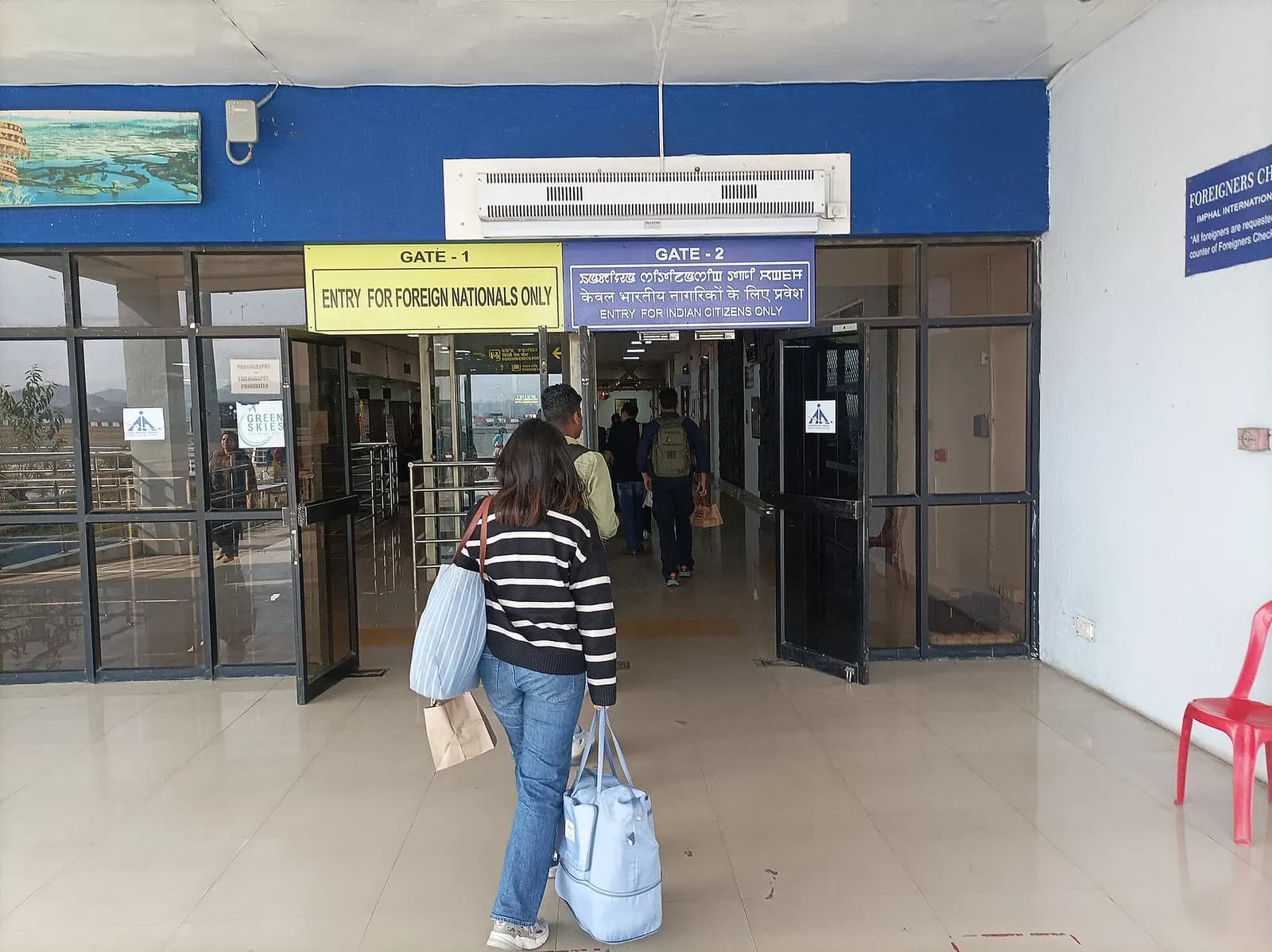 Passengers passing to & from the gates of foreign nationals & Indian citizens in the Imphal International Airport ("Imphaal Leikoi Maalang Hithaangpham" in Meitei, the official language of Manipur state)
