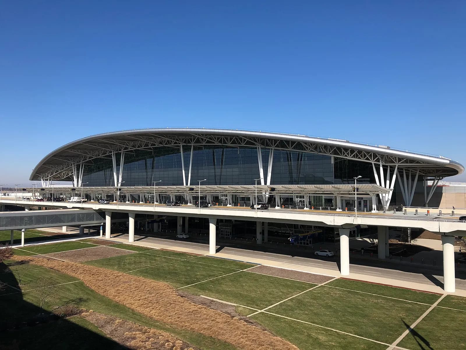 The photo depicts Indianapolis International Airport's Colonel H. Weir Cook Terminal, looking northeast from the airport's parking structure.