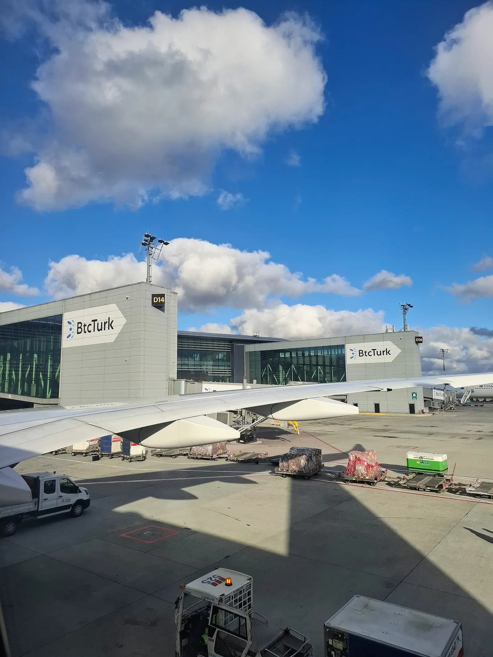 Exterior facade of Istanbul Airport showing curved modern terminal architecture from the forecourt in daylight.
