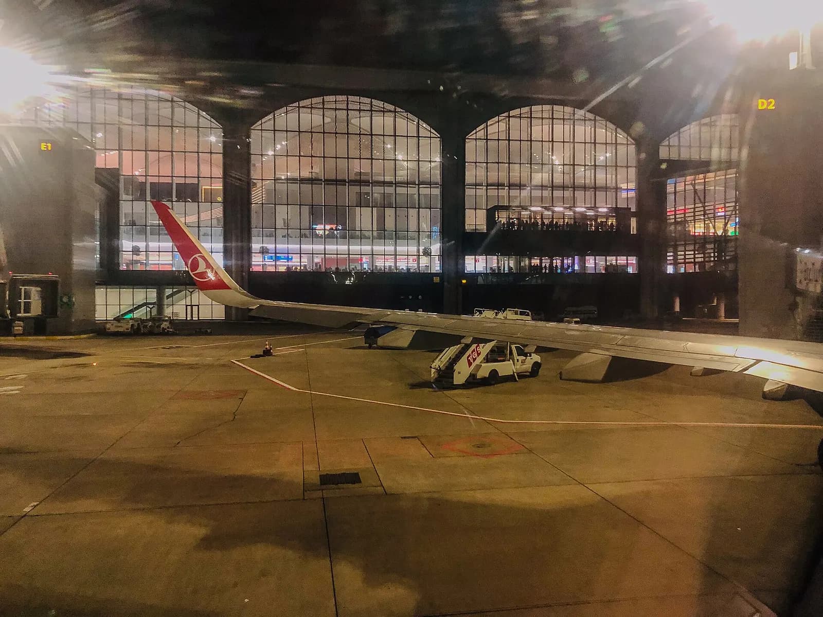 Istanbul Airport terminal and airfield lights glowing after dark against the night sky.