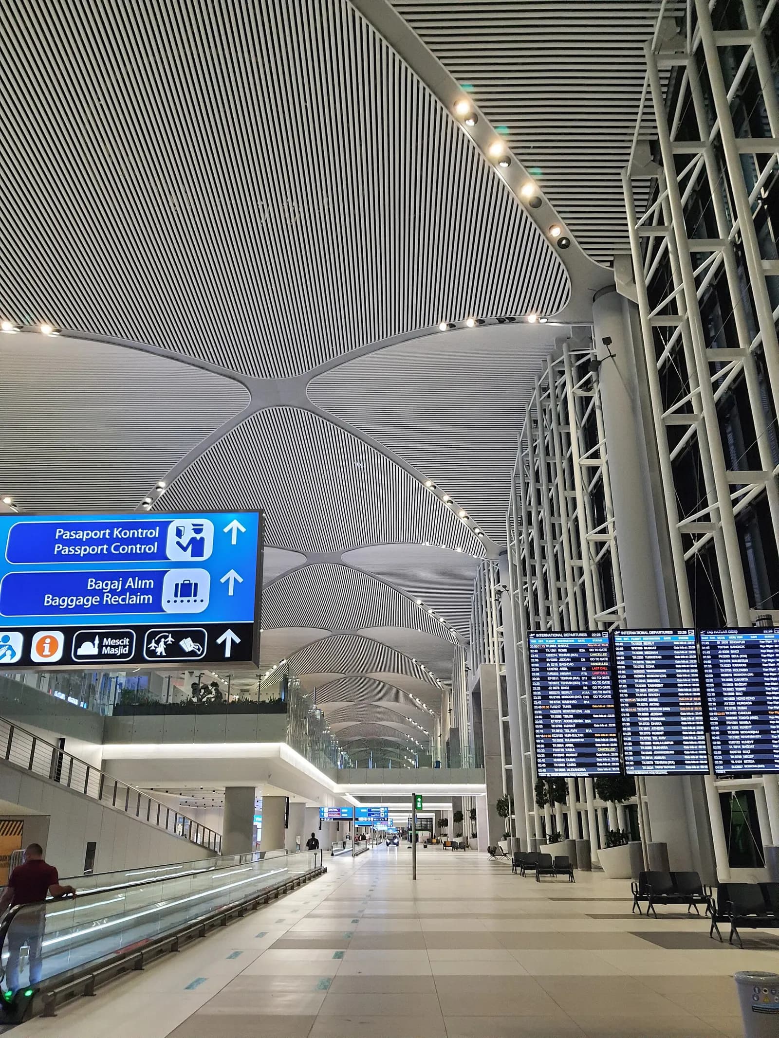 Arrivals area inside Istanbul Airport with open hall space, signage, and passengers in the international arrivals zone.