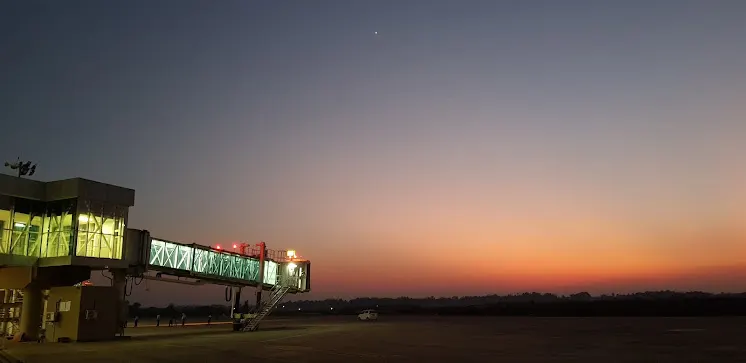 Twilight view of an aerobridge and apron lights at Maharaja Bir Bikram Airport, Agartala.