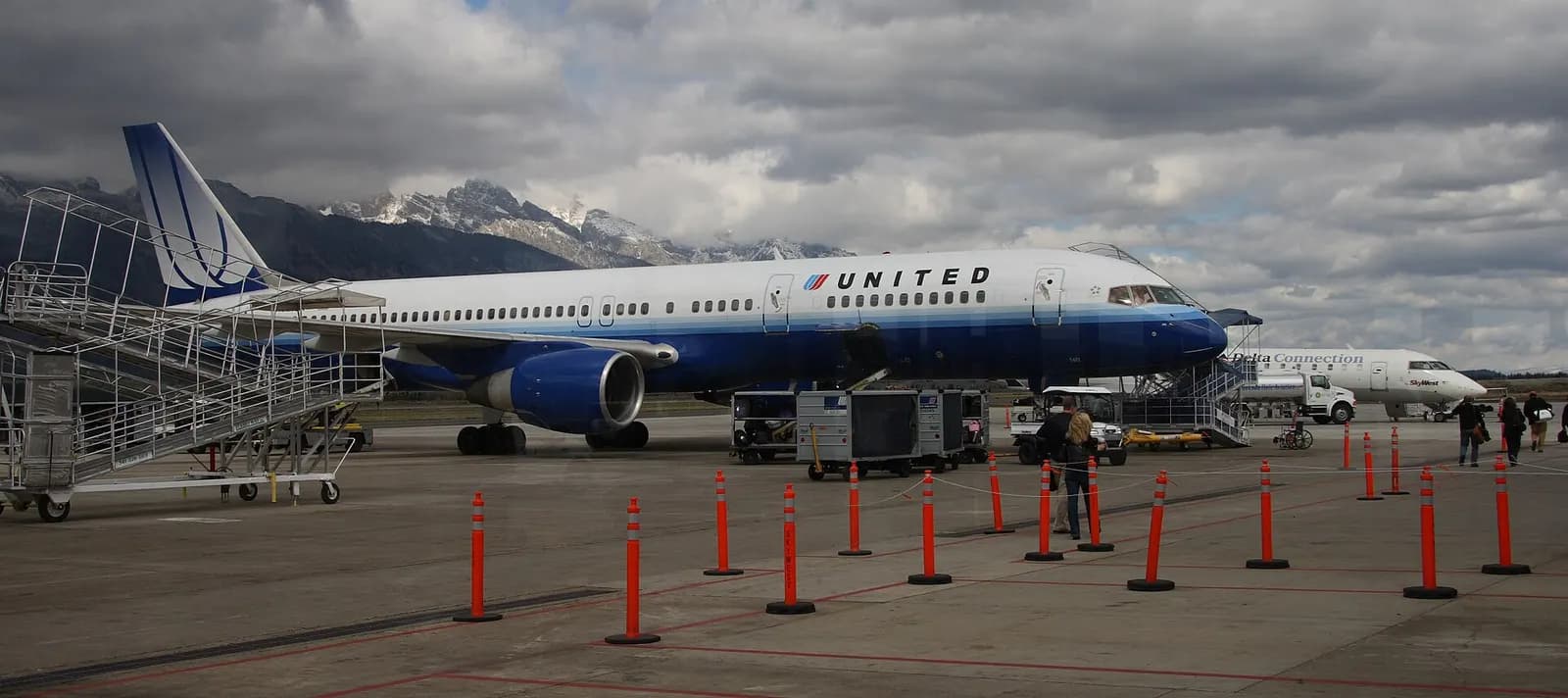 September 2007 ramp view at Jackson Hole Airport with the Teton Range behind parked airliners.
