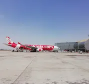 AirAsia X widebody parked on the apron at Jaipur International Airport.