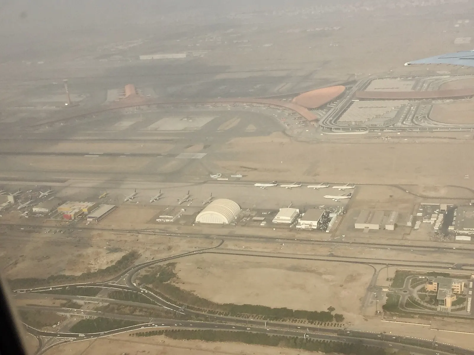 An aerial photograph shows the South Terminal in the foreground and the larger Terminal 1 complex behind it at King Abdulaziz International Airport.
