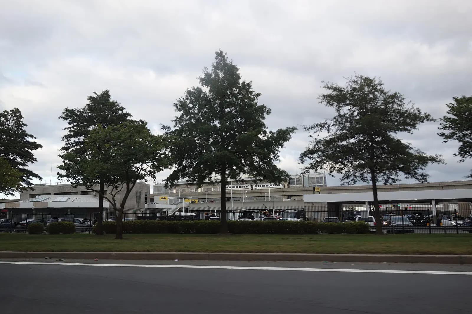 Traveling counterclockwise around the Federal Circle roundabout in John F. Kennedy International Airport, at the Van Wyck Expressway near South Ozone Park, Queens. Pictured is the AirTrain station in the distance to the east.