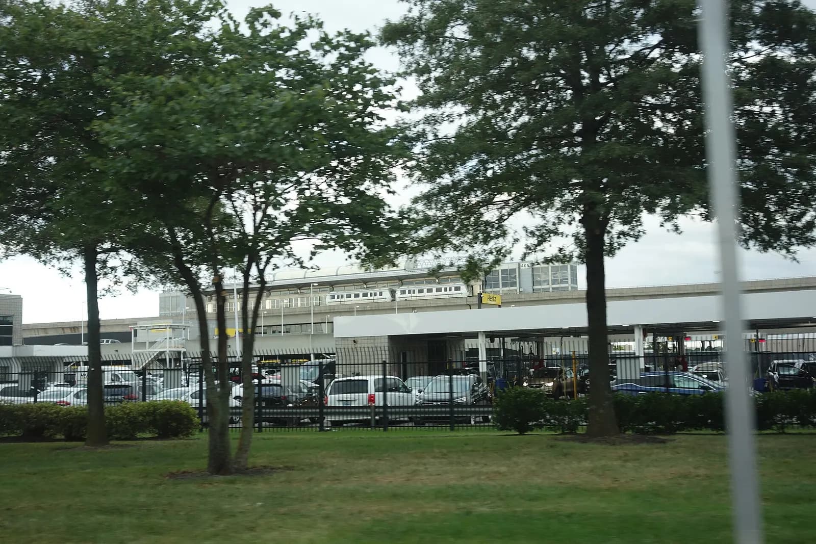 Traveling counterclockwise around the Federal Circle roundabout in John F. Kennedy International Airport, at the Van Wyck Expressway near South Ozone Park, Queens. Pictured is the AirTrain station in the distance to the east.