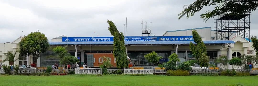 Earlier Jabalpur Airport terminal façade with AAI / JABALPUR AIRPORT signage and IndiGo visible inside — Dumna, Madhya Pradesh