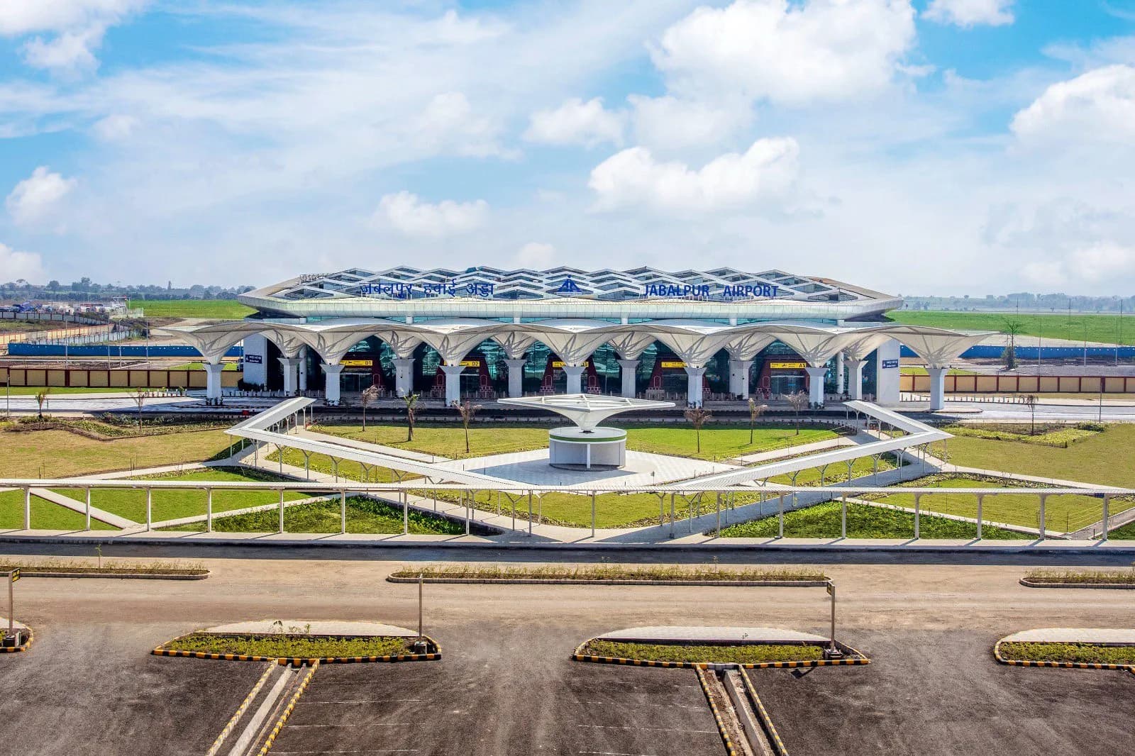 New Jabalpur Airport terminal exterior with JABALPUR AIRPORT / जबलपुर हवाई अड्डा façade signage — Dumna, Madhya Pradesh