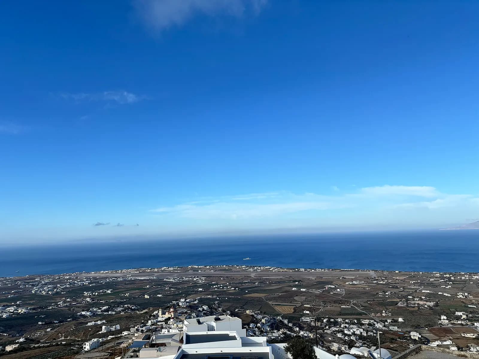Santorini International Airport runway and coastal plain seen from Pyrgos Kallistis in May 2024