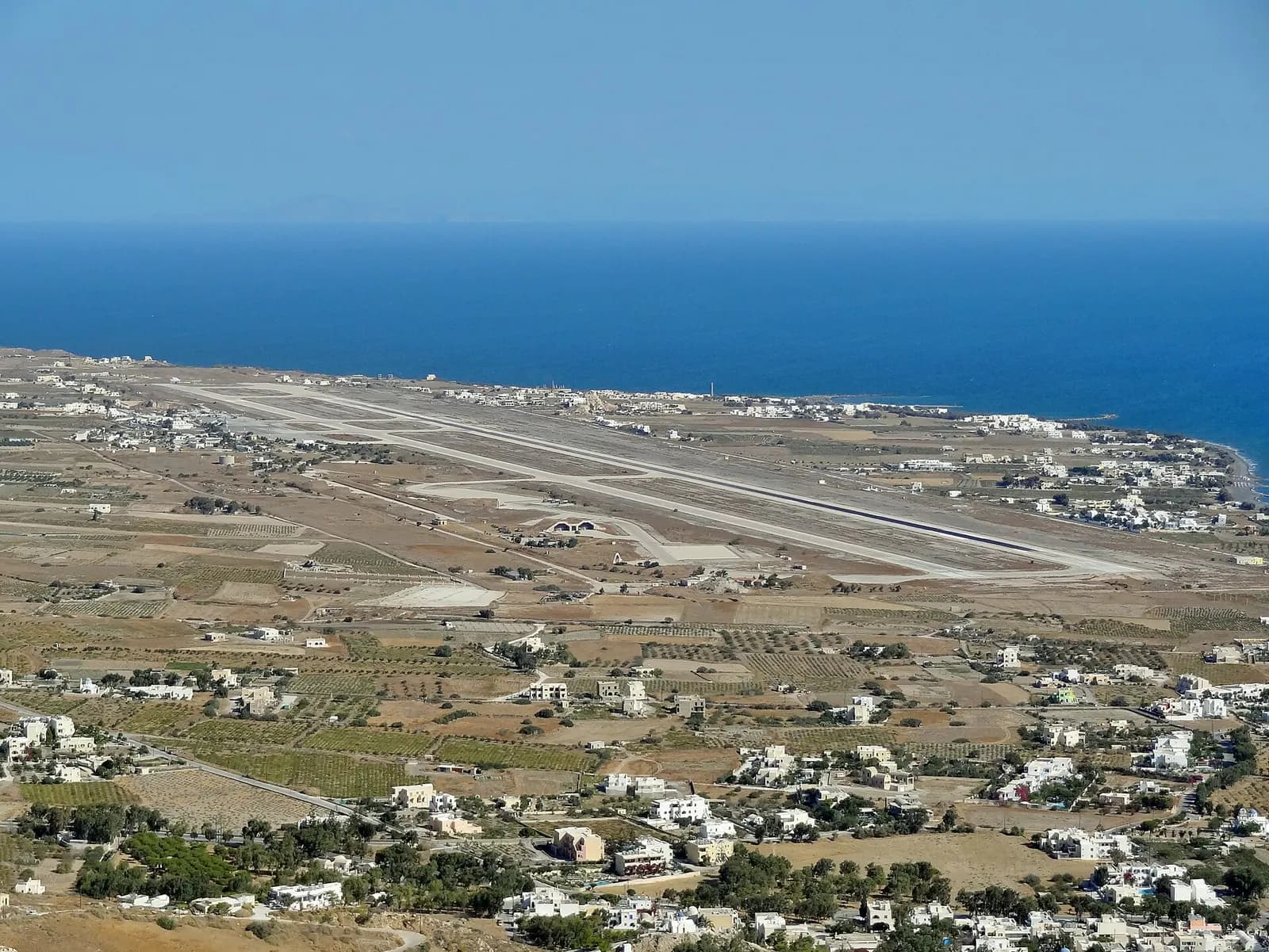 Santorini Airport airfield and Kamari coastal strip from a high ridge on Thira