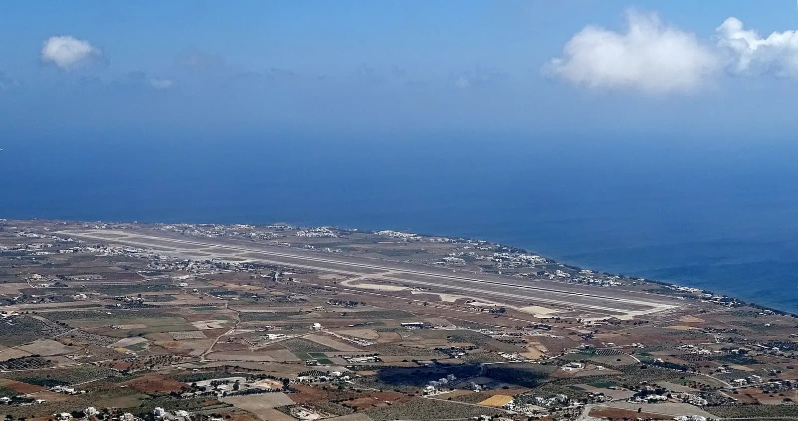 Santorini Airport runway and taxiway viewed from Mount Profitis Ilias toward the sea