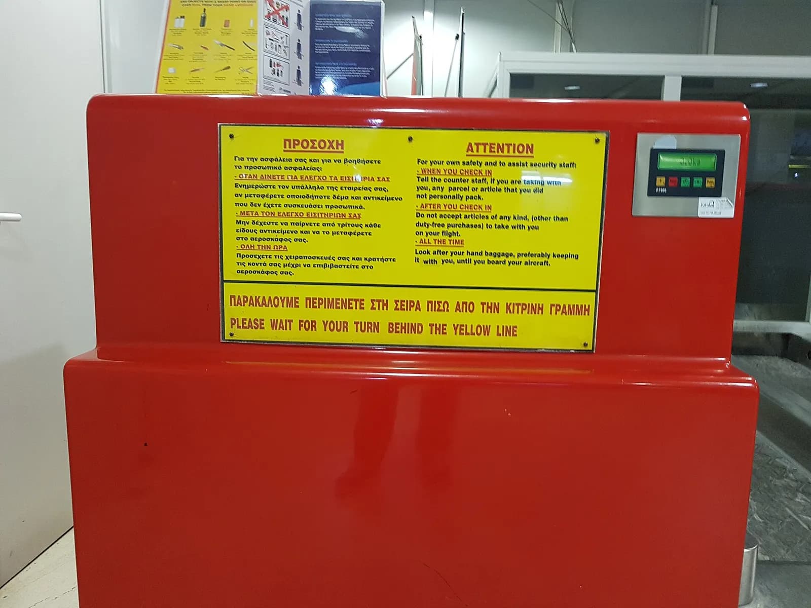 Check-in instructions signage inside Kos Ippokratis Airport.