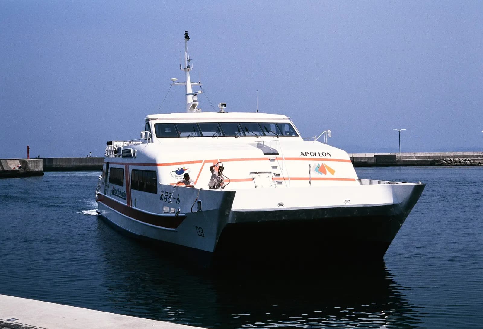 The high-speed Bay Shuttle ferry Apollon arriving at a harbor on the Kansai Airport sea route.