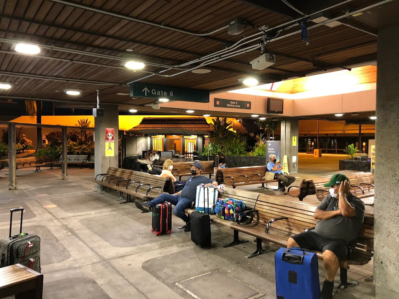 Open-air Gate 6 waiting area at Kona International Airport at night