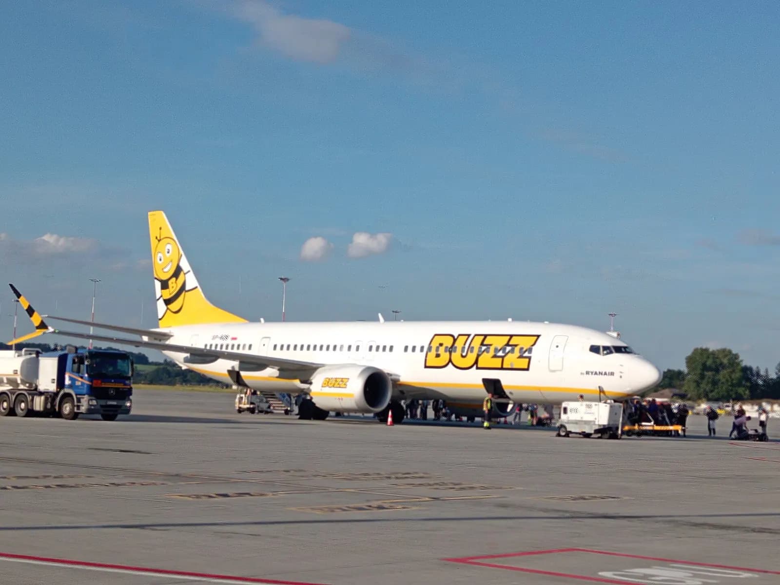 Buzz Ryanair airline branding and service counters inside Kraków Airport's passenger terminal.