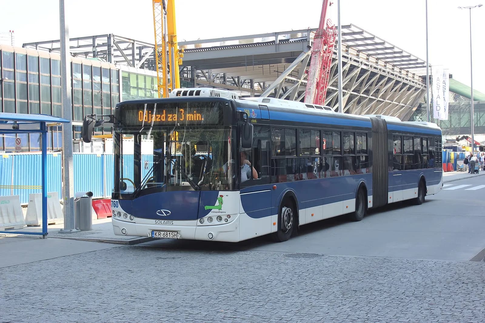 A Solaris Urbino 18 city bus marked PR760 on route 292 stopped at Kraków-Balice John Paul II International Airport.
