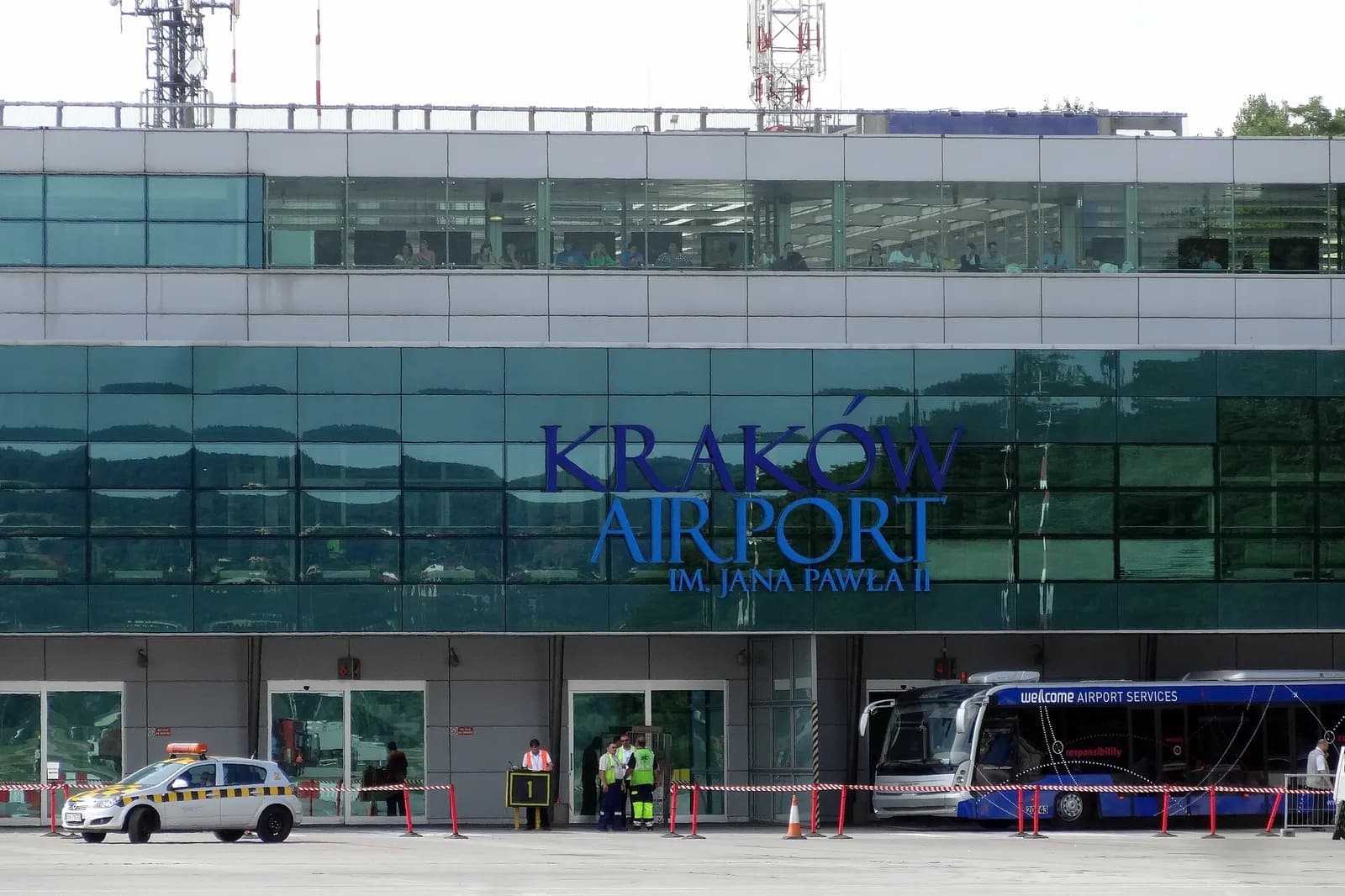 Exterior overview of Kraków John Paul II International Airport showing the terminal complex and surrounding airfield.