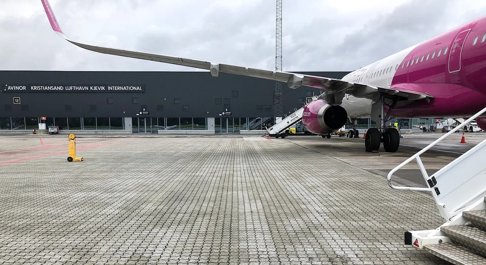 Airside façade of the international terminal of Kristiansand Airport, Kjevik in Southern Norway. Picture taken on Fri. 27SEP 2019. This part of the terminal building at KRS was constructed/opened in 2015. The Wizz Air flight is being handled locally by Aviator Airport Alliance, and is here seen at g
