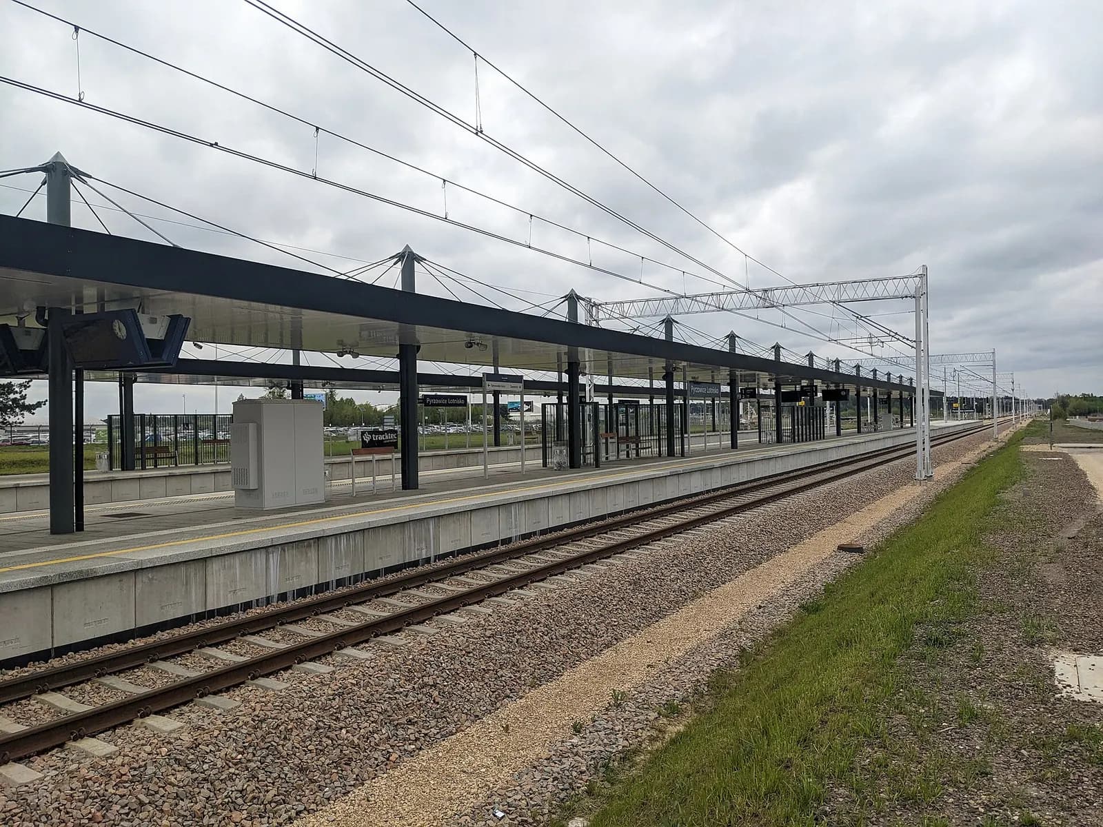 The Pyrzowice Lotnisko railway station platform and station building beside the tracks that serve Katowice Airport.