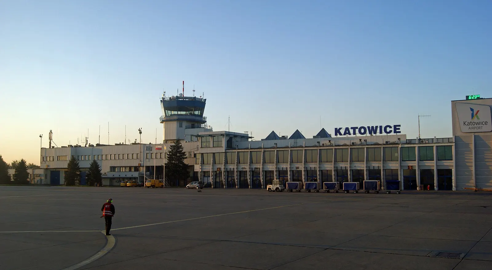A wide daytime view of Katowice International Airport in Pyrzowice showing the terminal buildings, apron, and surrounding airfield.