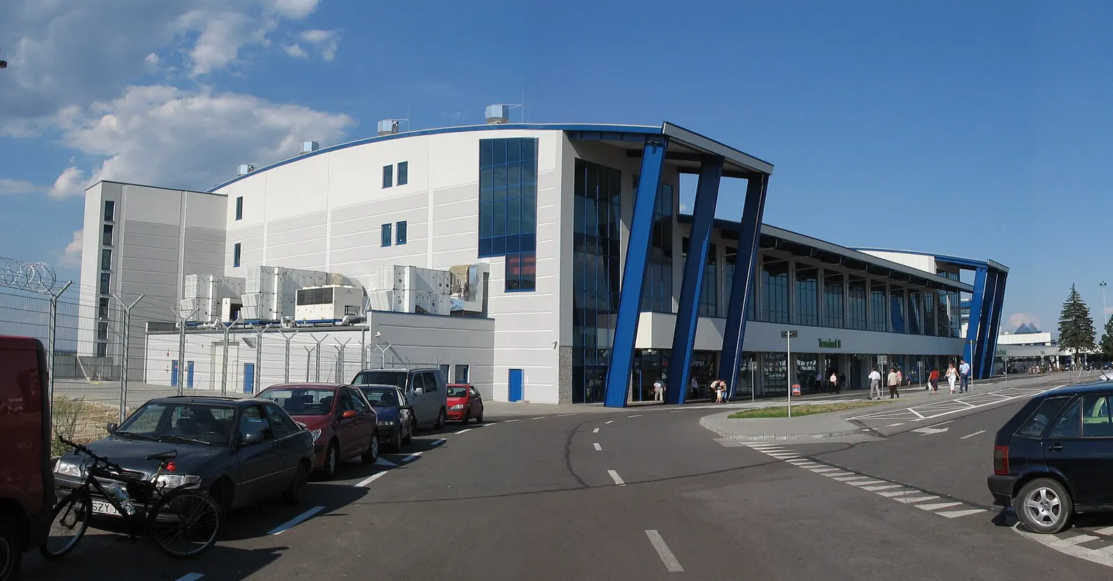 The long, modern Terminal B building at Katowice Airport viewed from outside along the access road.