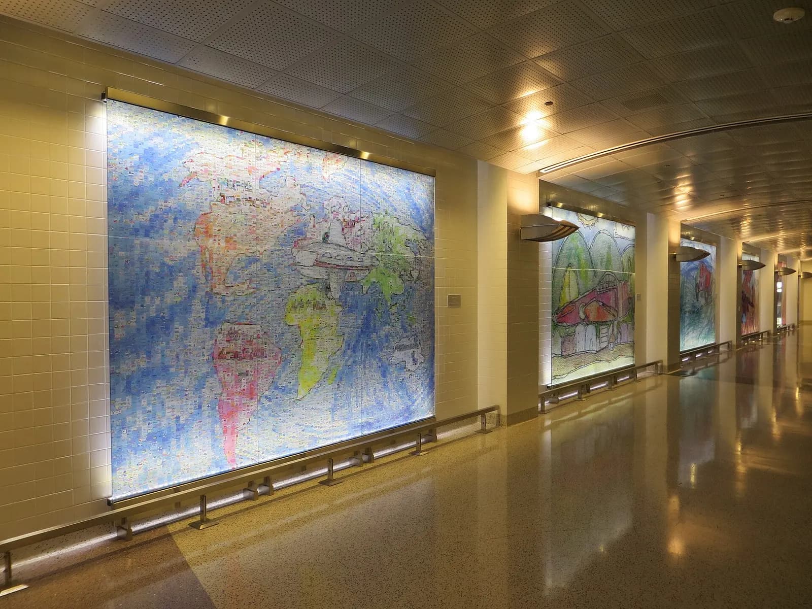 Colorful student artwork mounted along the walls of the D Gates automated tram station.