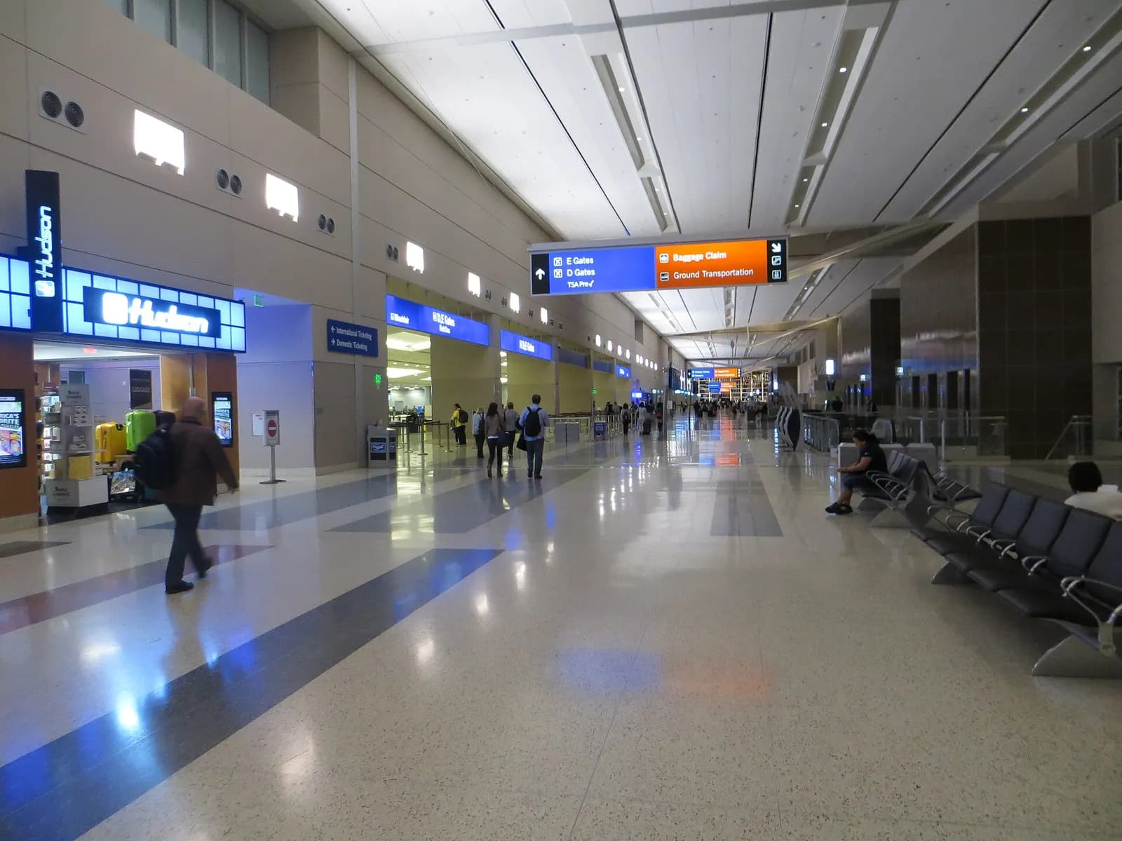 Landside departure level at Terminal 3 showing the terminal facade, roadway, and passenger drop-off area.