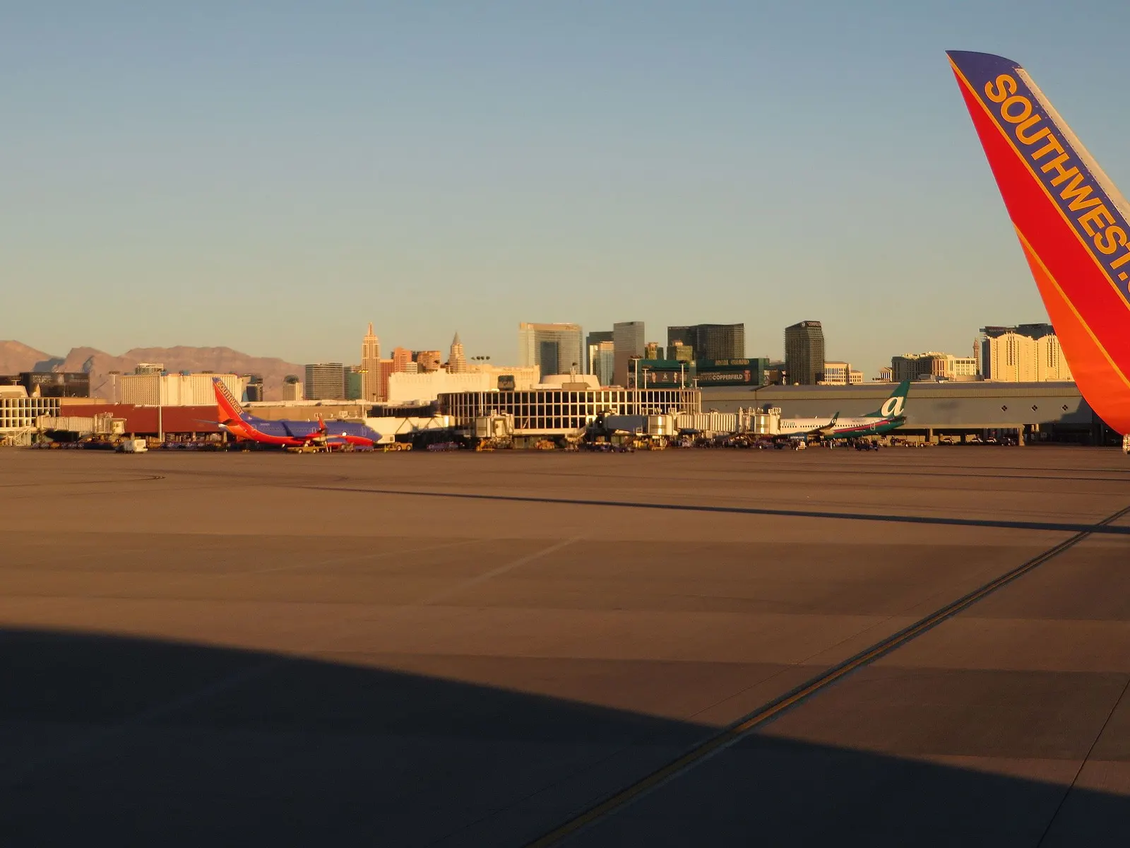View from Harry Reid International Airport across the desert toward the Las Vegas Strip skyline and resort towers.