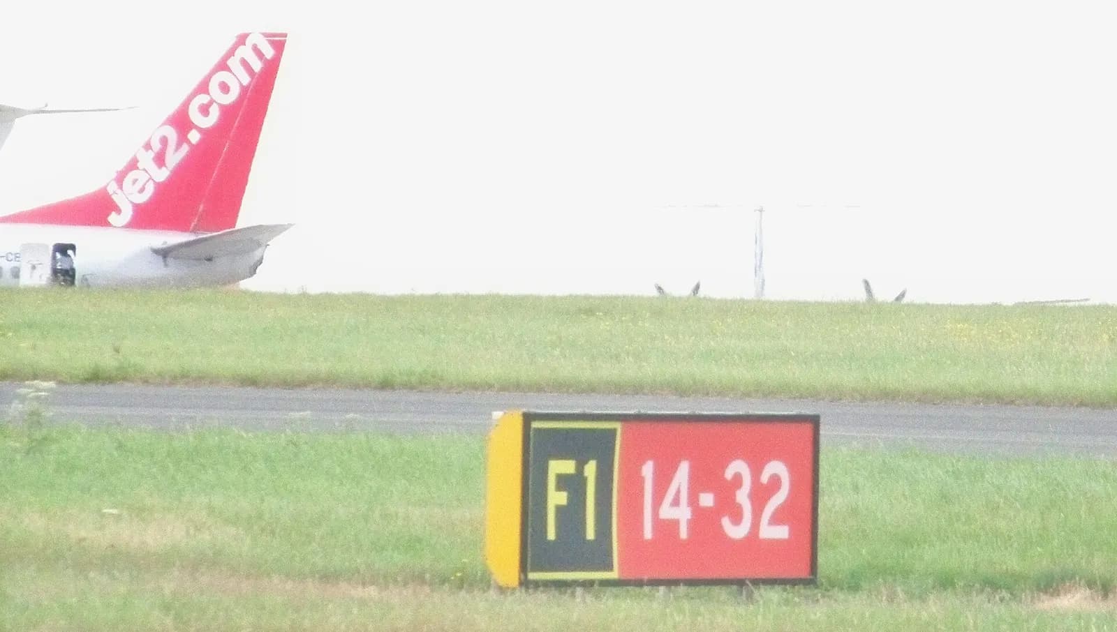 Aircraft seen airside at Leeds Bradford International Airport. The propeller blades of a Flybe plane can be seen over the brow of the hill (it's not the flattest of airfields). As 
