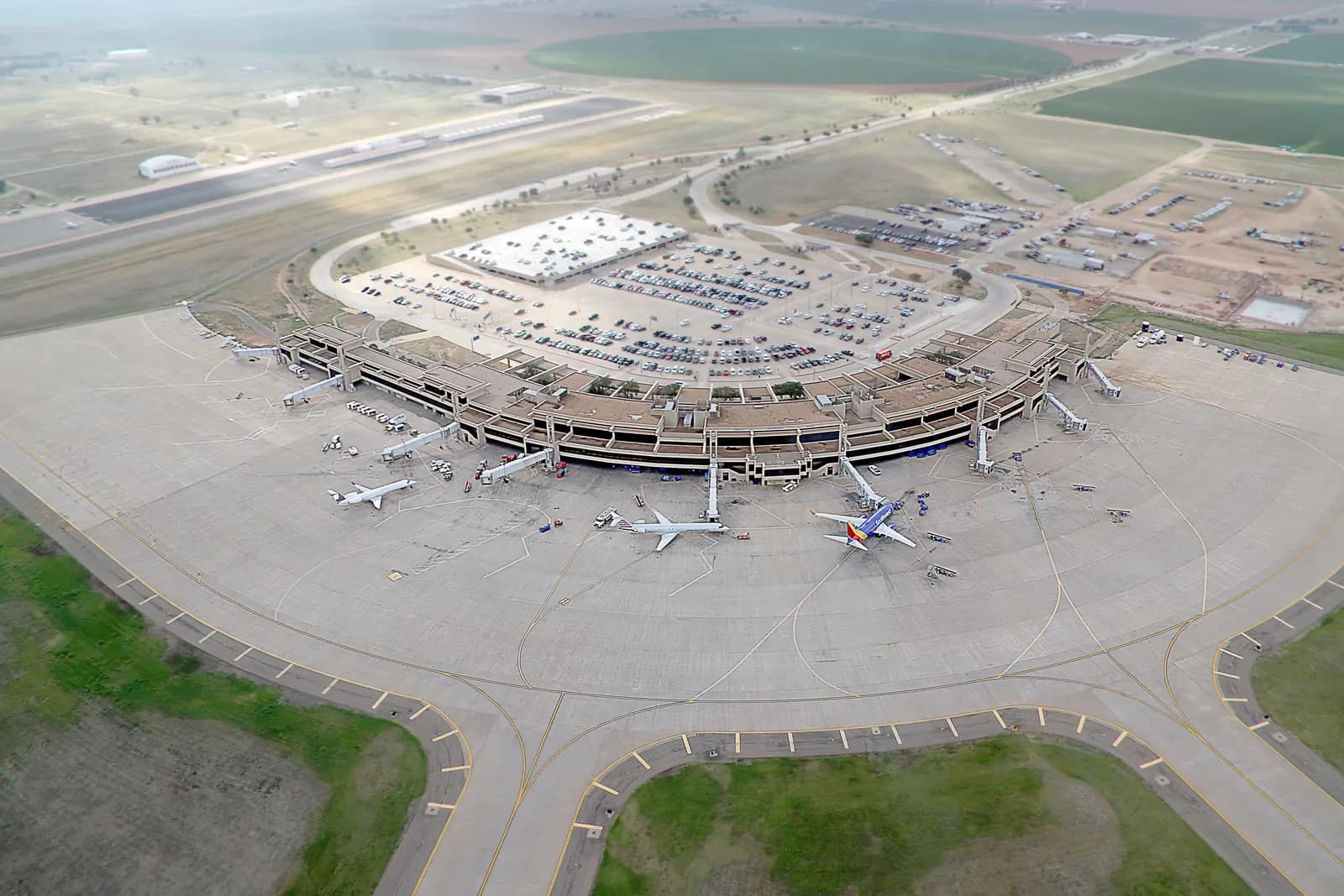 September 2018 aerial of Lubbock Preston Smith International Airport looking across the civil terminal, garage, and airfield.